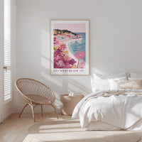 a bedroom with a large poster of a beach scene hanging on the wall, a wicker chair, and a bed with white bedding.