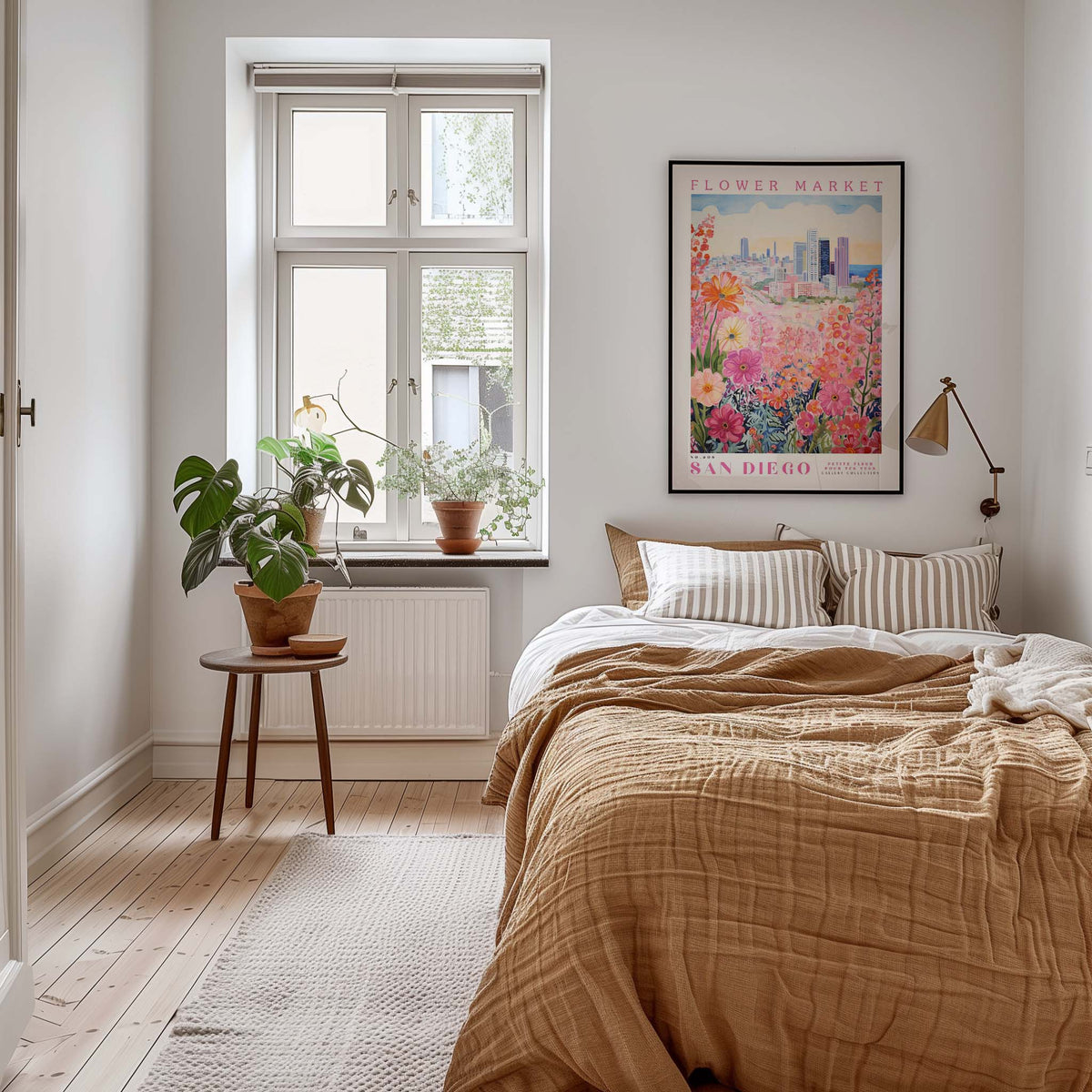 a cozy bedroom with a large bed, a nightstand with a plant, and a framed poster of a flower market in San Diego.