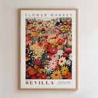 The image is a framed poster depicting a vibrant and colorful flower market in Seville, Spain.