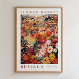 The image is a framed poster depicting a vibrant and colorful flower market in Seville, Spain.