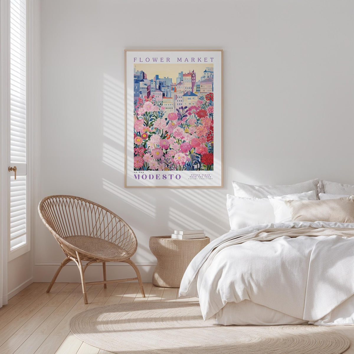 a bedroom with a large poster of a flower market hanging on the wall, a woven chair, and a bed with white bedding.