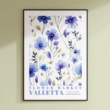 a blue flower market poster hanging on a wall