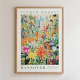 The image is a framed poster depicting a vibrant and colorful flower market scene.