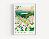 The image is a framed poster depicting a scenic landscape with a field of white flowers in the foreground and a body of water in the background. The poster is framed in a wooden frame and hangs on a wall.