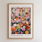 The image is a framed poster of a vibrant floral arrangement, featuring a variety of colorful flowers and plants.