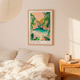a bedroom with a framed poster of a tropical island landscape hanging on the wall above a bed with striped bedding.