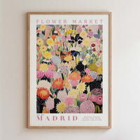 The image is a framed poster of a vibrant and colorful floral arrangement, likely from a flower market.