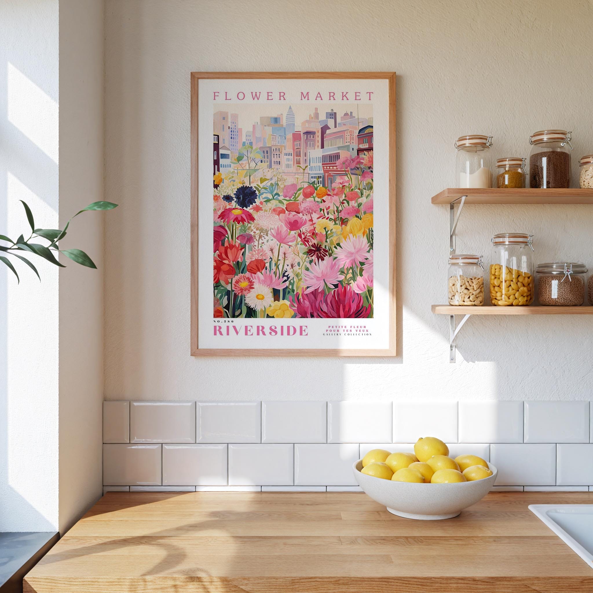 a kitchen scene with a framed poster of a flower market on the wall, a wooden counter with a bowl of lemons, and shelves with jars and containers.