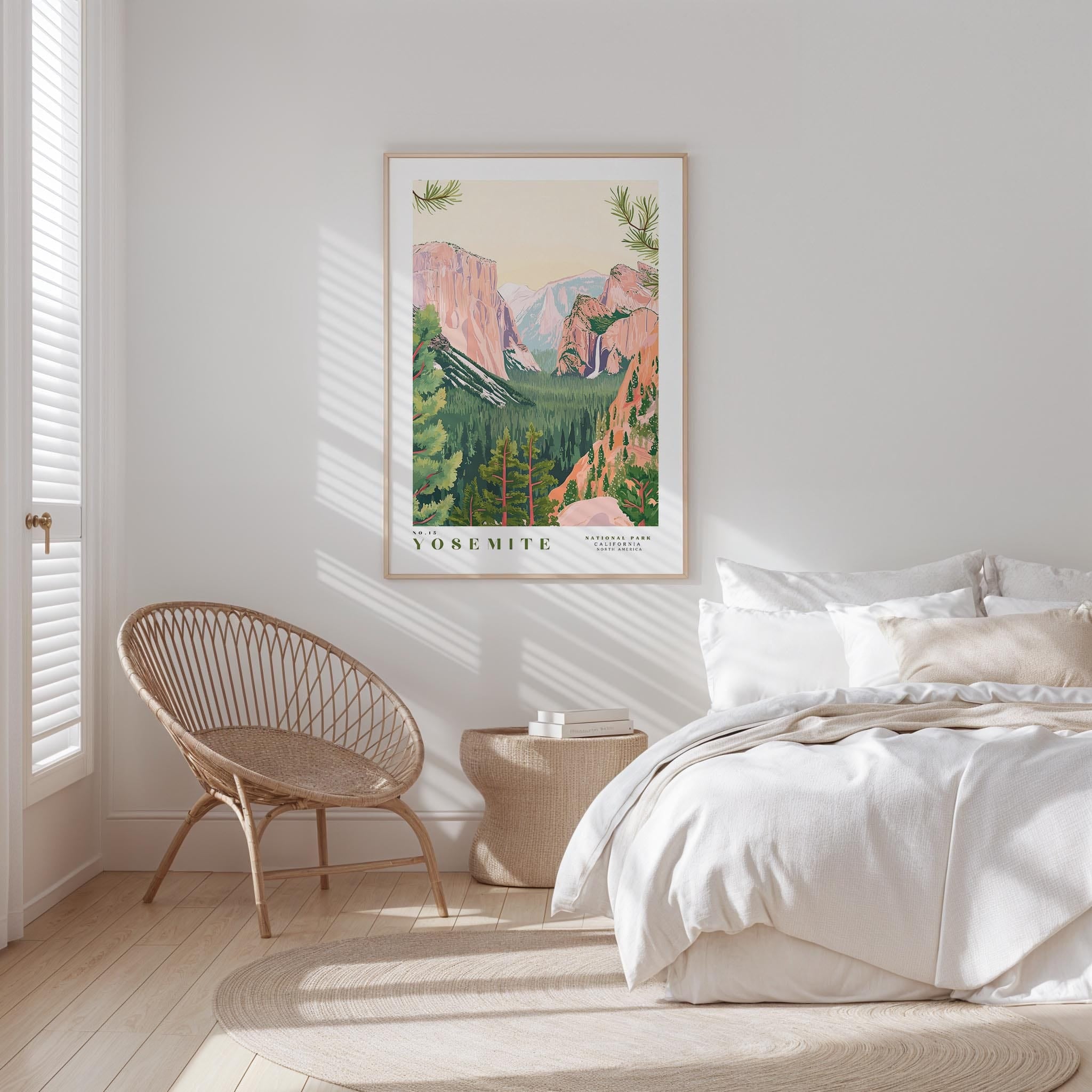a bedroom with a large framed poster of Yosemite National Park hanging on the wall above a bed with white bedding.