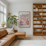 a cozy living room with a large window, a comfortable leather couch, a bookshelf filled with books, and a framed poster of a flower market in Krakow hanging on the wall.