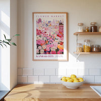 a framed poster of a flower market in Kansas City, with a wooden counter and shelves displaying various jars and containers in the background.