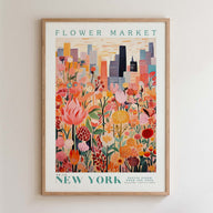 The image is a framed poster depicting a vibrant and colorful illustration of a flower market in New York City, with tall buildings and a city skyline in the background.