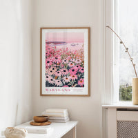 a framed poster of a field of flowers, specifically a field of daisies, hanging on a wall.