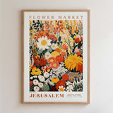 The image is a framed poster depicting a vibrant and colorful floral arrangement, with various types of flowers and foliage. The poster is titled "Flower Market Jerusalem" and is framed with a wooden border.