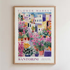 The image is a framed poster depicting a vibrant and colorful flower market in Santorini, Greece.