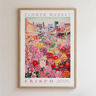 The image is a framed poster depicting a vibrant and colorful street scene with a variety of flowers and plants.