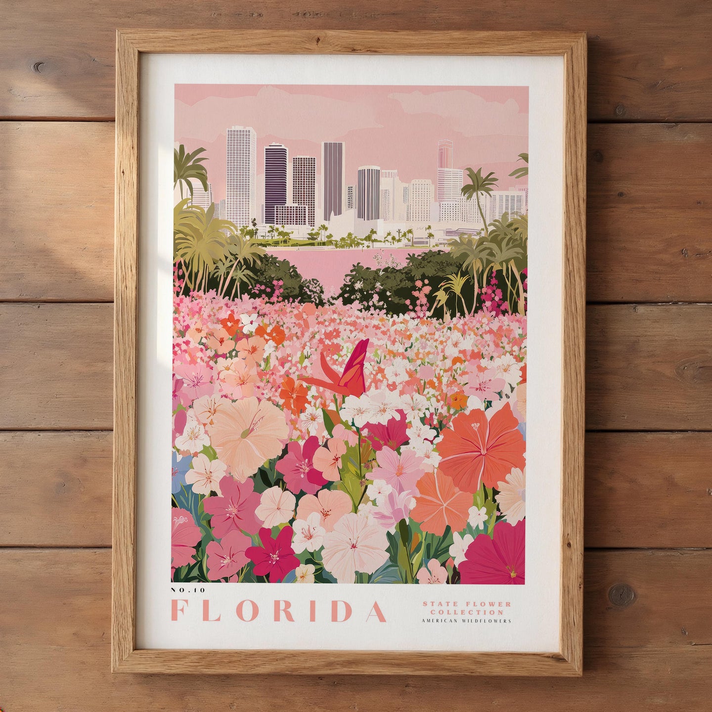 A framed poster depicting a vibrant field of flowers with a city skyline in the background.