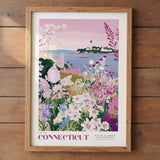 A framed poster depicting a scenic landscape with a lighthouse, flowers, and a body of water, all set against a pink and purple sky.