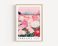 A framed poster depicting a vibrant field of pink and white flowers in the foreground, with a city skyline in the background.