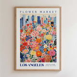 The image is a framed poster depicting a vibrant and colorful flower market in Los Angeles, California.
