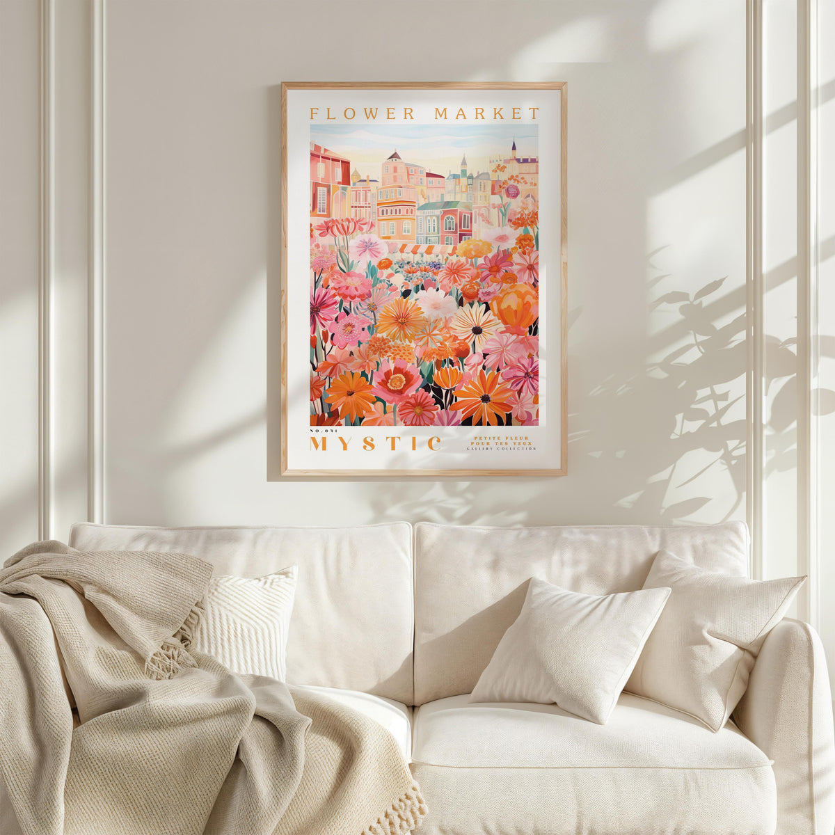 a cozy living room with a white sofa and a framed poster of a vibrant floral scene hanging on the wall above it.