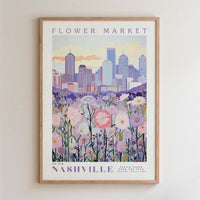 The image is a framed poster depicting a cityscape with a field of flowers in the foreground.
