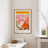 a framed poster of the Grand Canyon hanging on a wall, with a white table and a plant in the foreground.
