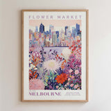 The image is a framed poster depicting a vibrant and colorful scene of a flower market in Melbourne, Australia.