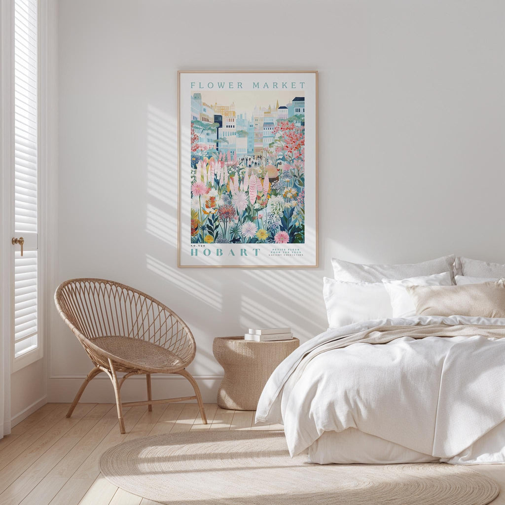 a bedroom with a large poster of a colorful floral scene hanging on the wall above a bed with white bedding.