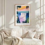 a framed poster of Victoria Falls hanging on a wall above a white couch with a blanket draped over it.