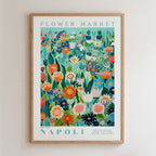 The image is a framed poster depicting a vibrant and colorful floral scene, with various flowers and plants arranged in a visually appealing manner.