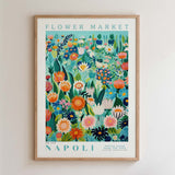The image is a framed poster depicting a vibrant and colorful floral scene, with various flowers and plants arranged in a visually appealing manner.