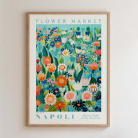 The image is a framed poster depicting a vibrant and colorful floral scene, with various flowers and plants arranged in a visually appealing manner.