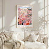 a framed poster of a flower market in Beaulfort, with a pink and white color scheme and a cityscape background.