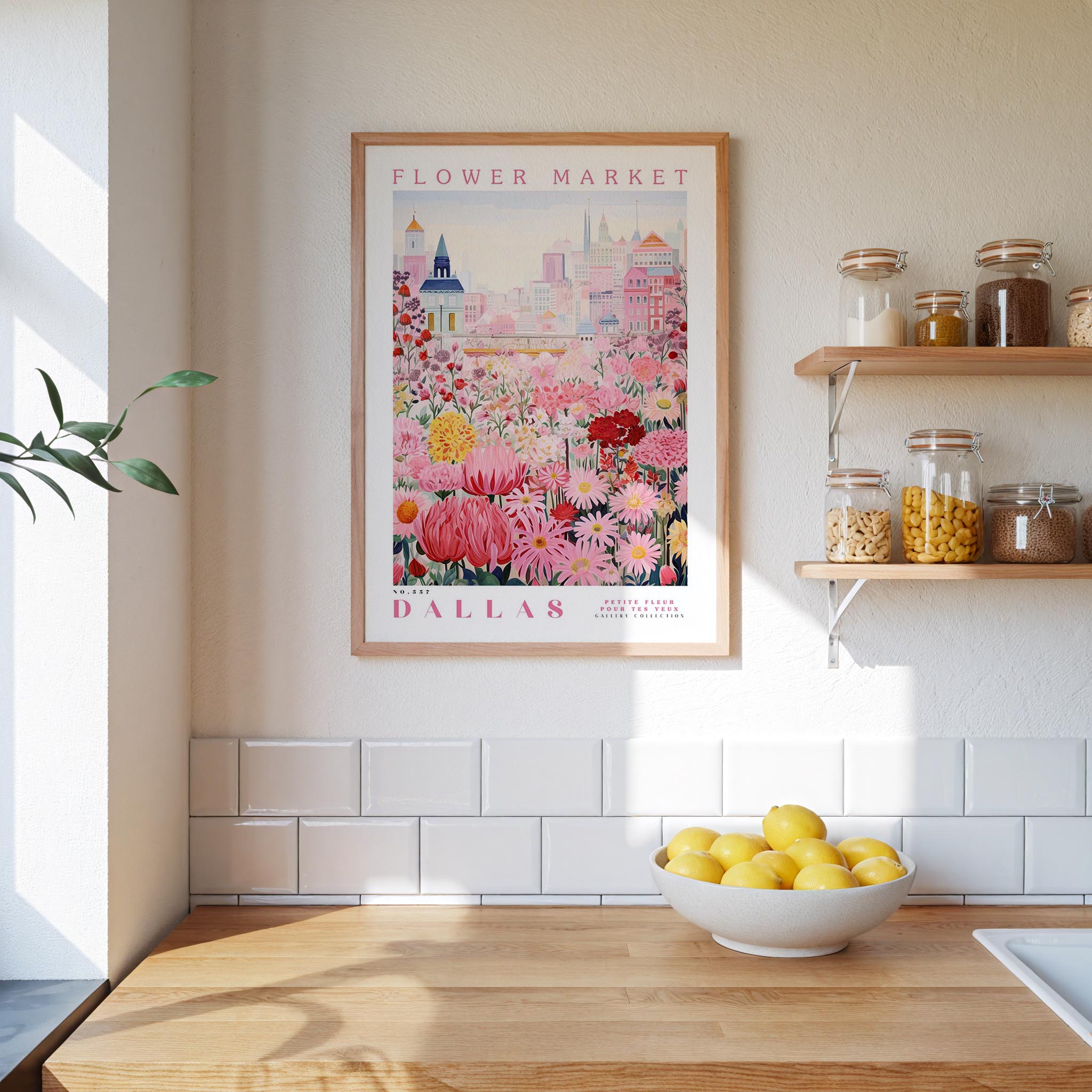 a framed poster of a colorful floral scene hanging on a wall above a wooden countertop with a bowl of lemons.