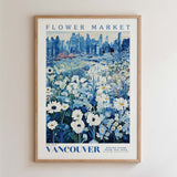 The image is a framed poster depicting a cityscape with a field of flowers in the foreground.