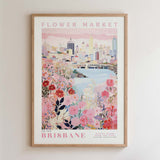 The image is a framed poster depicting a cityscape with a flower market in the foreground.