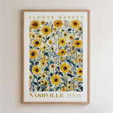 The image is a framed poster of a field of yellow sunflowers, with the text "FLOWER MARKET" and "NASHVILLE" printed on it.
