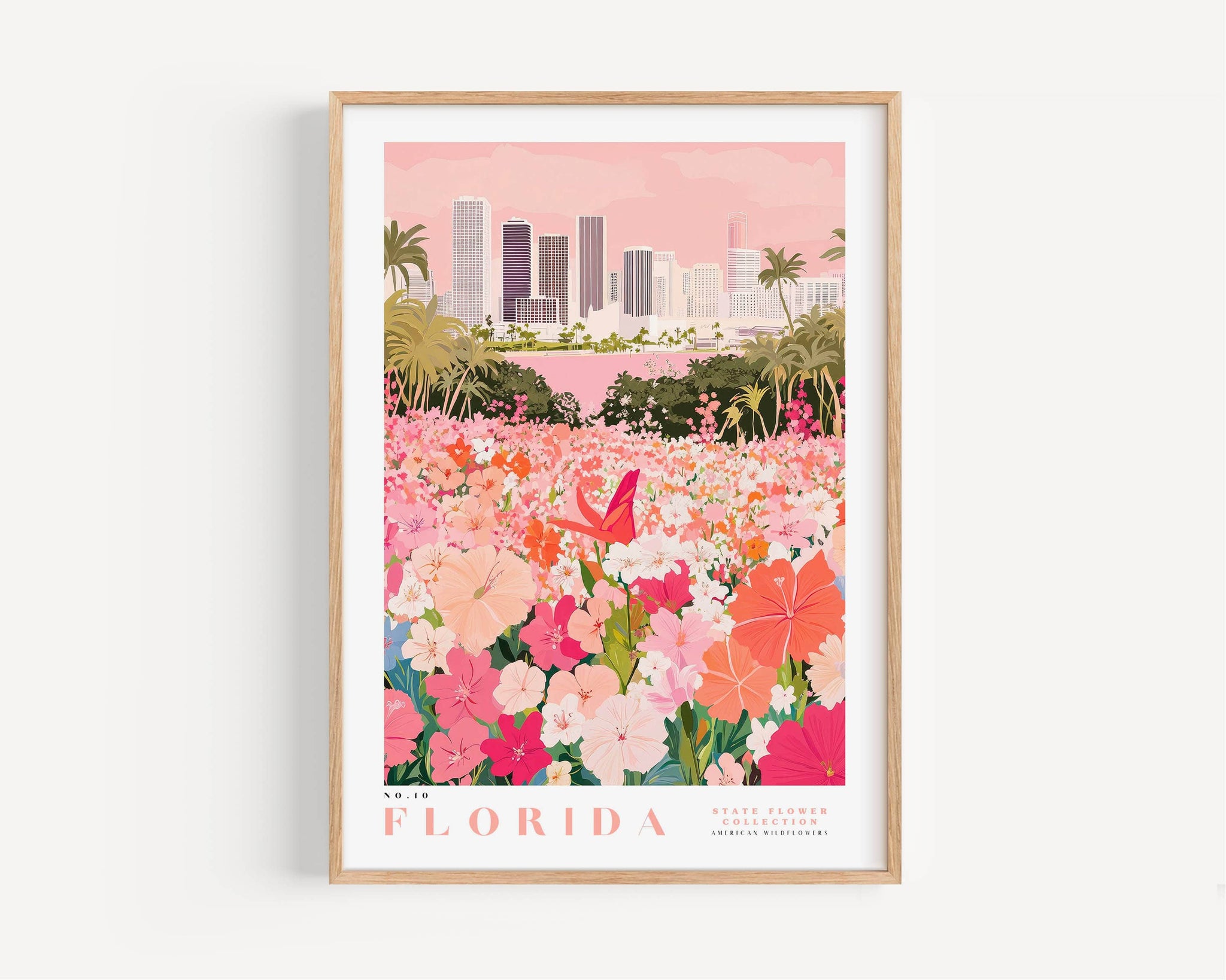 A framed poster depicting a vibrant cityscape with a field of colorful flowers in the foreground, including pink, orange, and white flowers.