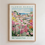 The image is a framed poster depicting a vibrant and colorful flower market in Mendocino, California.