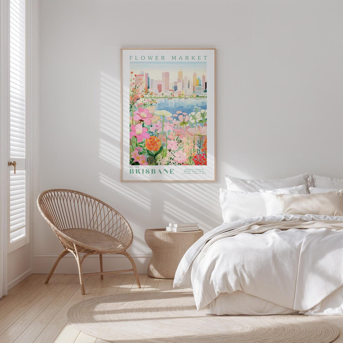 a bedroom with a bed, a woven chair, and a framed poster of the Brisbane Flower Market hanging on the wall.