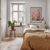 a cozy bedroom with a large bed, a nightstand with a plant, and a framed poster of a flower market on the wall.