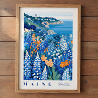 A framed illustration of a coastal landscape with a lighthouse, featuring a variety of colorful flowers and plants in the foreground.