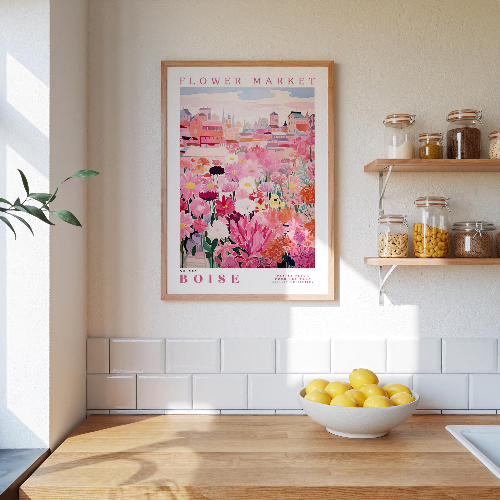 a kitchen scene with a framed poster of a flower market in Boise hanging on the wall above a wooden counter with a bowl of lemons.