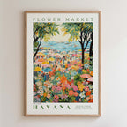 The image is a framed poster depicting a vibrant and colorful scene from the Havana Flower Market, with a variety of flowers, people, and umbrellas filling the frame.