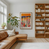 a cozy living room with a large bookshelf filled with books, a comfortable leather couch, and a framed poster of a field of flowers hanging on the wall.