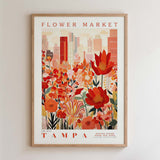 The image is a framed poster depicting a cityscape with a large, colorful flower garden in the foreground.