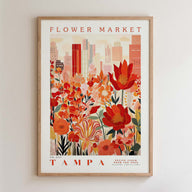 The image is a framed poster depicting a cityscape with a large, colorful flower garden in the foreground.