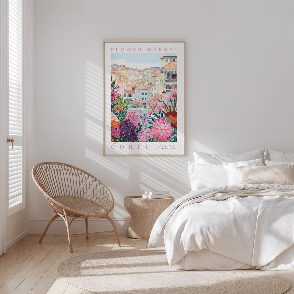 a bedroom with a large floral poster hanging on the wall, a woven chair, and a bed with white bedding.