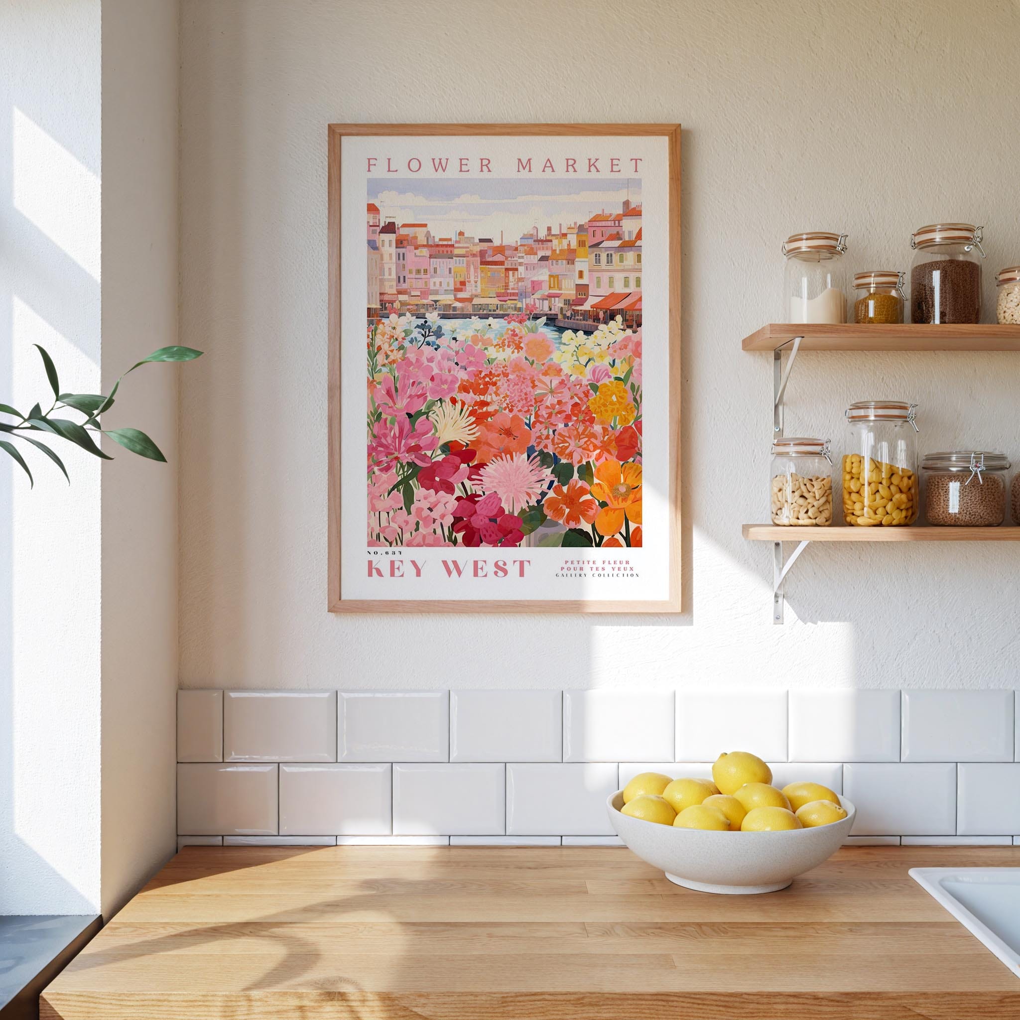 a kitchen scene with a framed poster of a flower market on the wall, a wooden counter with a bowl of lemons, and shelves displaying various jars and containers.